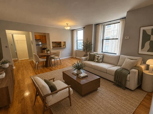 A living room with a couch, chairs, and a coffee table.