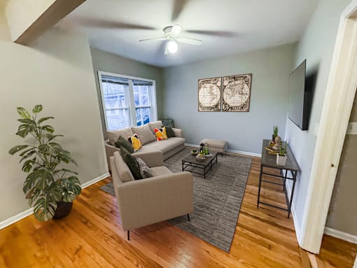 Barry Court  living room with furniture and a ceiling fan