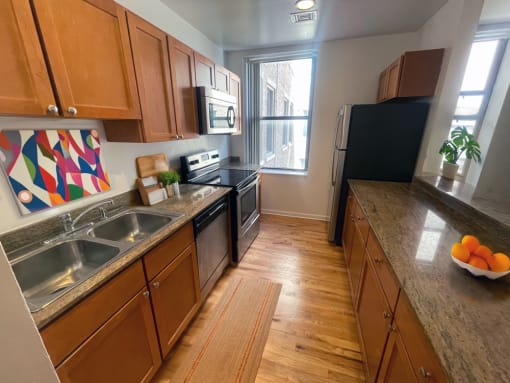 a kitchen with stainless steel appliances and wooden cabinets