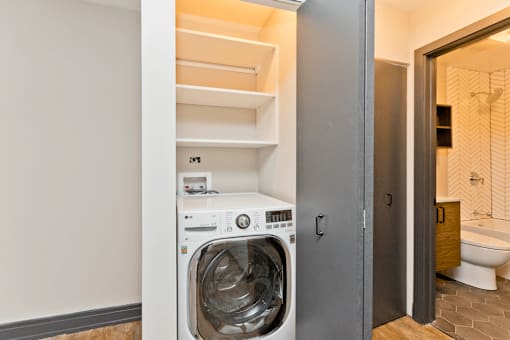 A washing machine is in a small room.