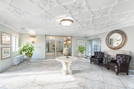 A white room with a round mirror and a table.