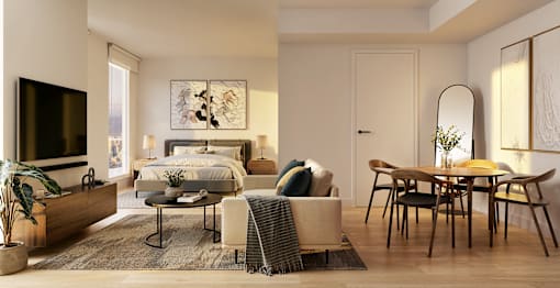 A modern bedroom with a large bed, a TV, a table and chairs, and a rug.