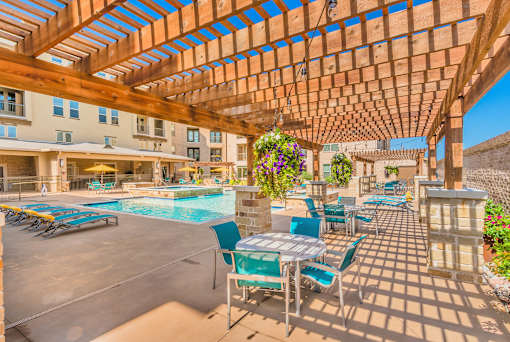A wooden pergola over a poolside seating area at Atlas Point at Prestonwood Apartments , Carrollton, TX, 75010