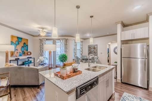 A modern kitchen with a large island and stainless steel appliances at Atlas Point at Prestonwood Apartments , Carrollton, TX, 75010