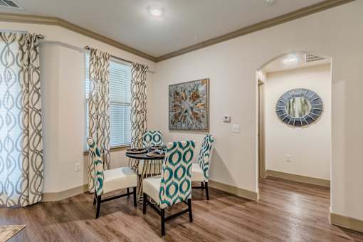 A dining room with a table and chairs. at Atlas Point at Prestonwood Apartments , Carrollton