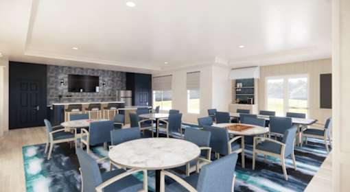 Business center with blue chairs and workstations at Chestnut Oaks Apartments, Maryland