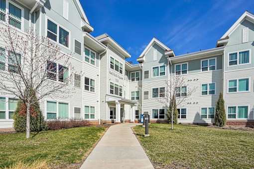 A large white building with a walkway in front.