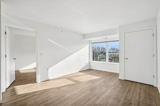 A room with wooden floors and white walls.