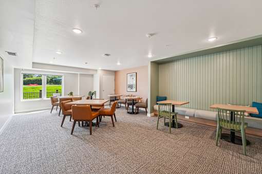 A room with a long table and chairs.