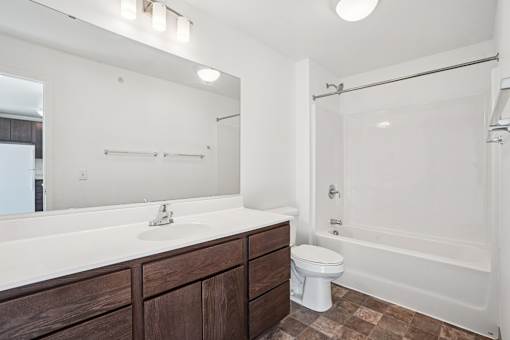A bathroom with a sink, toilet, and bathtub.
