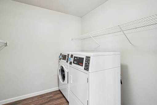 A white washing machine and dryer in a laundry room.