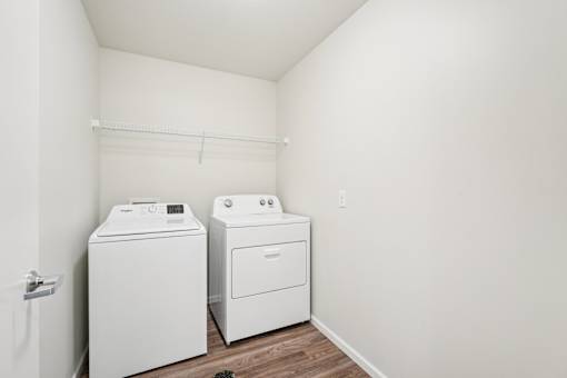 A white washer and dryer in a small laundry room.