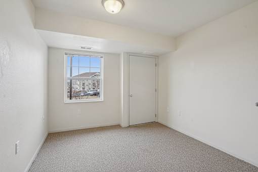 A room with a window and a door is shown.