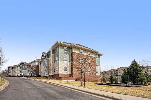 A street view of a residential area with apartment buildings.