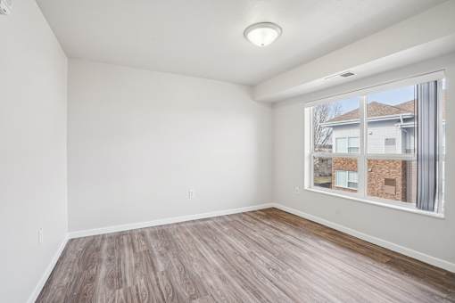 Empty room with a window showing a building outside.