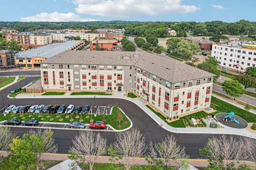 A large building with a parking lot in front of it.