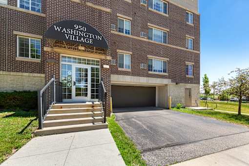 The front of a building with the sign "950 Washington Village" above the entrance.