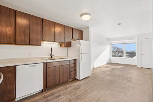 A kitchen with wooden cabinets and white appliances.