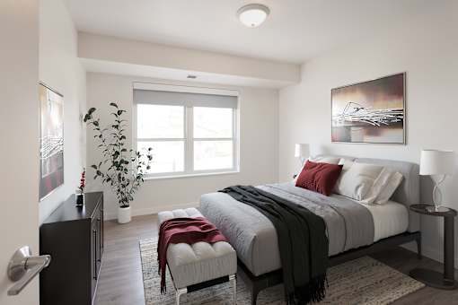 A bedroom with a large bed and a painting on the wall.
