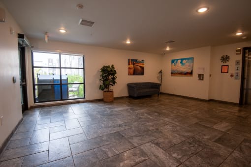 a large living room with a sliding glass door and tile floors
