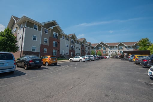 an empty parking lot in front of an apartment building