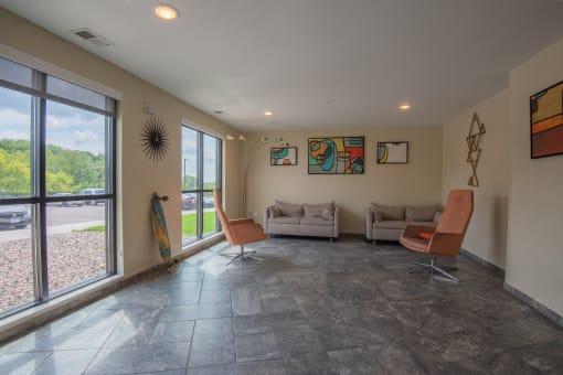 a living room with couches and chairs and a large window