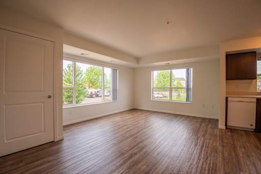 A room with wooden floors and a white door.