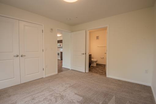 A room with a carpeted floor and white walls.