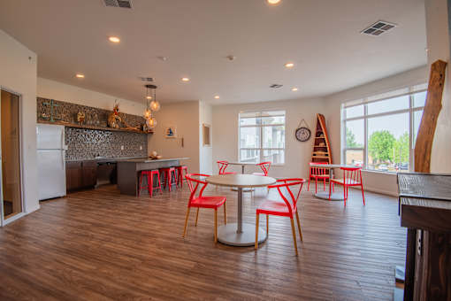 A kitchen with a dining table and chairs.