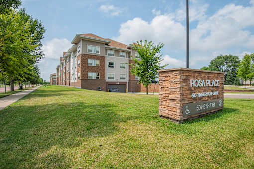 A brick building with a sign that says Rosage in front of it.