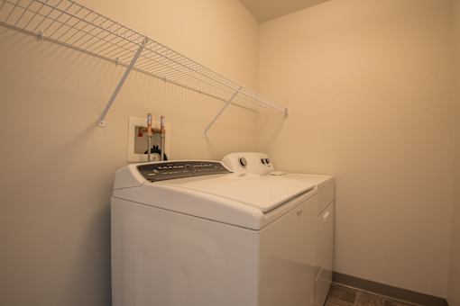 A white washing machine in a laundry room.