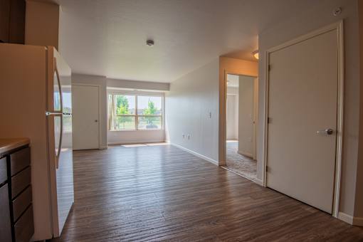 A room with wooden floors and white walls.