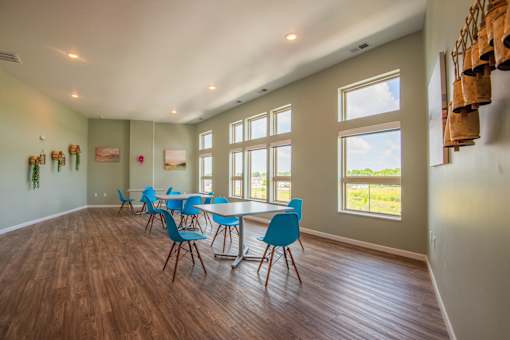 A room with a long table and chairs.