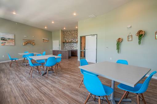A room with a long table and chairs.