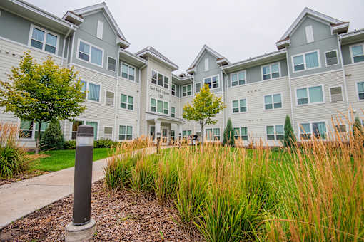 A grassy area in front of apartment buildings.