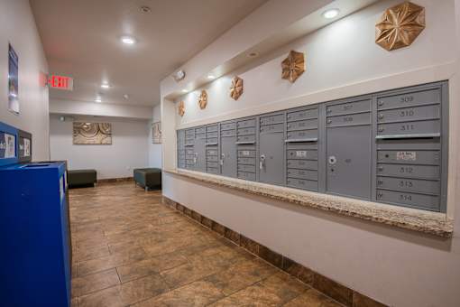 A row of mailboxes are lined up on a wall.