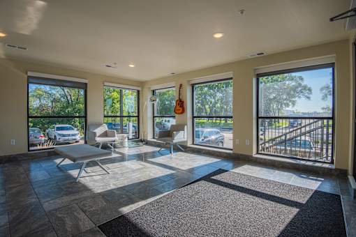A sunny day in a spacious living room with a balcony.