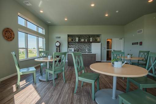 A dining room with a round table and chairs.