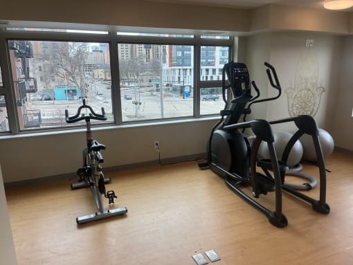 a gym with a view of the city from the window