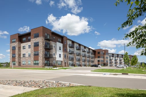 an exterior view of an apartment building on a city street