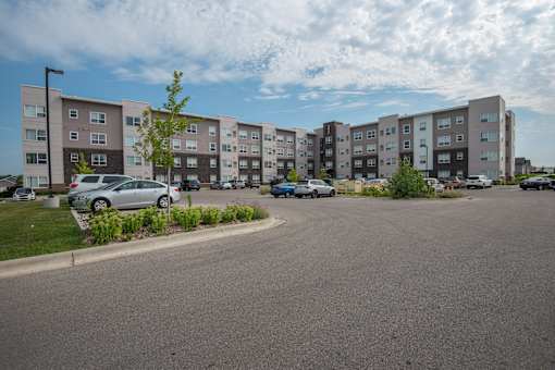 A parking lot in front of apartment buildings.