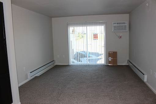 A room with a window and a car outside.
