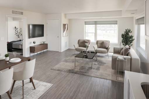 A modern living room with a wooden floor and furniture.