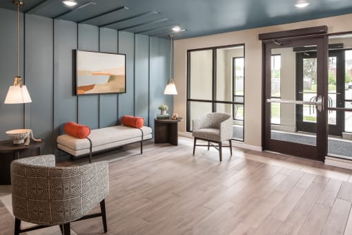 a lobby with couches and chairs and a blue wall