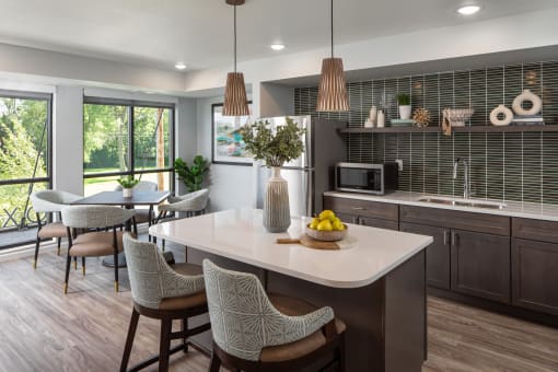 a kitchen with a large island and a table with chairs