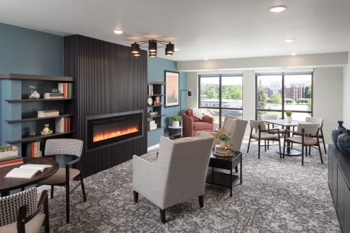 a living room with a fireplace and a table and chairs