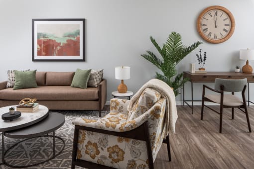 a living room with a couch and a clock on the wall