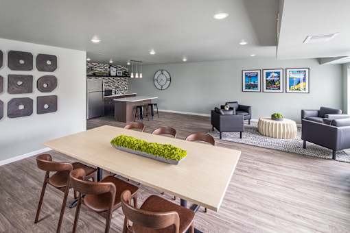 A modern dining room with a long table and chairs.