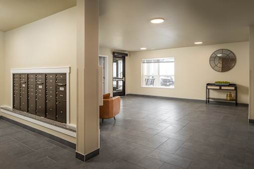 A room with a row of filing cabinets and a table with a fan on it.