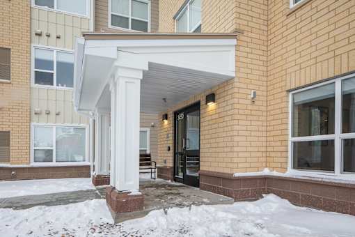 A building with a white overhang and a snowy ground.